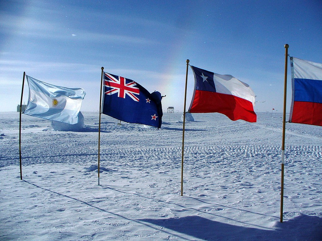Flags of Argentina, New Zealand, Chile, and Russia at the ceremonial South Pole. : Amble on Wikimedia Commons