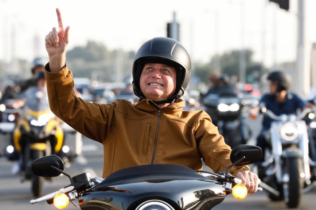 Brazilian President Jair Bolsonaro demonstrating his ‘military strong man’ credentials by riding a motorbike. : Alan Santos/PR CC 2.0