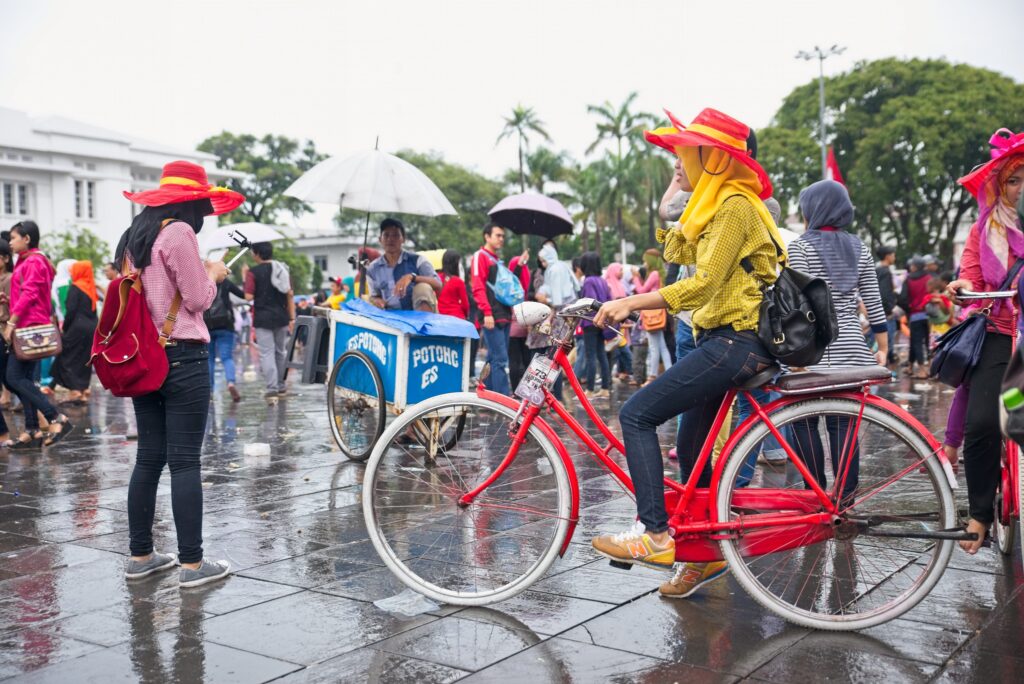 After a long and slippery road, students and academics in Indonesia now have a decree to protect them against sexual crime : “Woman on bicycle” by Indigo Skies Photography is available at https://bit.ly/3V2nBQX CC BY 2.0