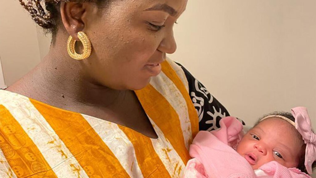 Pain myths chiuldbirth Mofoluwake Jones holds her daughter