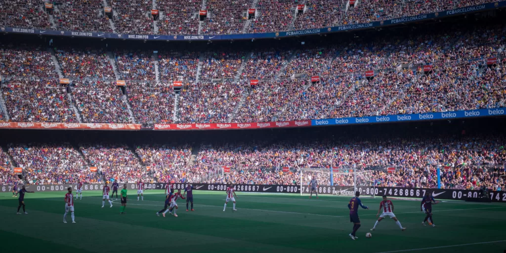 Football fans may have opinions about sportswashing but their voices are unlikely to be heard. : ‘Soccer field’ by Michael Lee is available at https://tinyurl.com/5n6ar3ma Copyright License: Unsplash