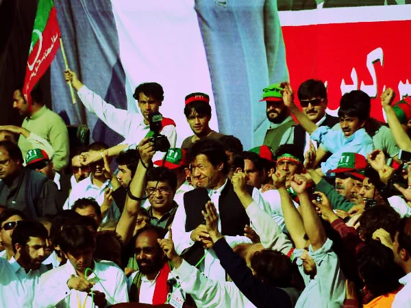 Imran Khan and supporters at a rally. Despite Imran’s ban, the PTI  still has a two point lead over its closest competitor, the Pakistan Muslim League-Nawaz, or PML(N). CCBY3.0