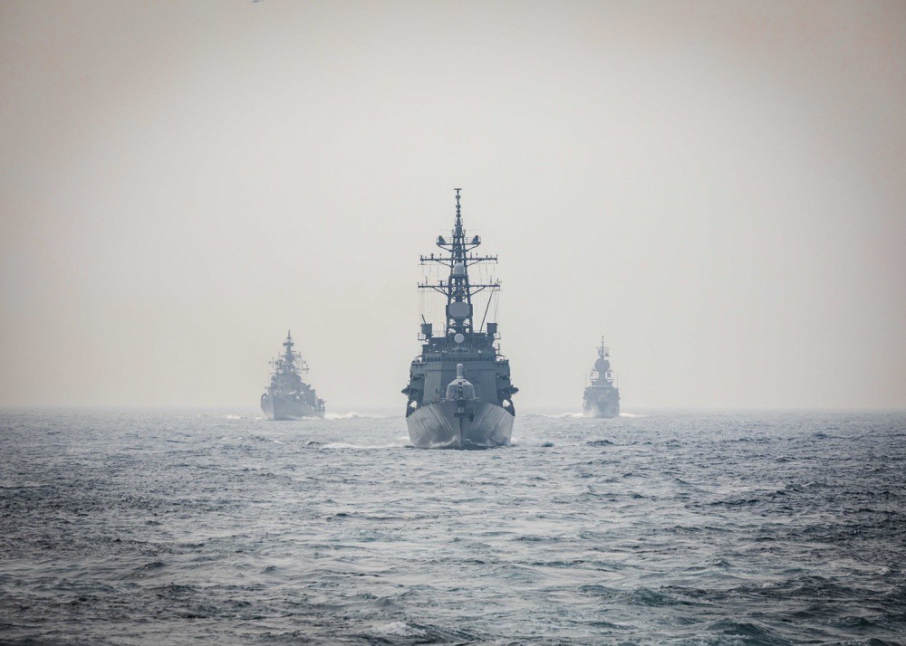 Ships from the Indian Navy, Royal Australian Navy, and Japan Maritime Self-Defence Force make their approach toward the Arleigh Burke-class guided-missile destroyer USS John S. McCain while conducting replenishment-at-sea approaches as part of Malabar 2020. Malabar is an India-led multinational exercise designed to enhance cooperation between these navies. : U.S. Navy photo by Markus Castaneda CC BY-NC-ND 2.0 DEED