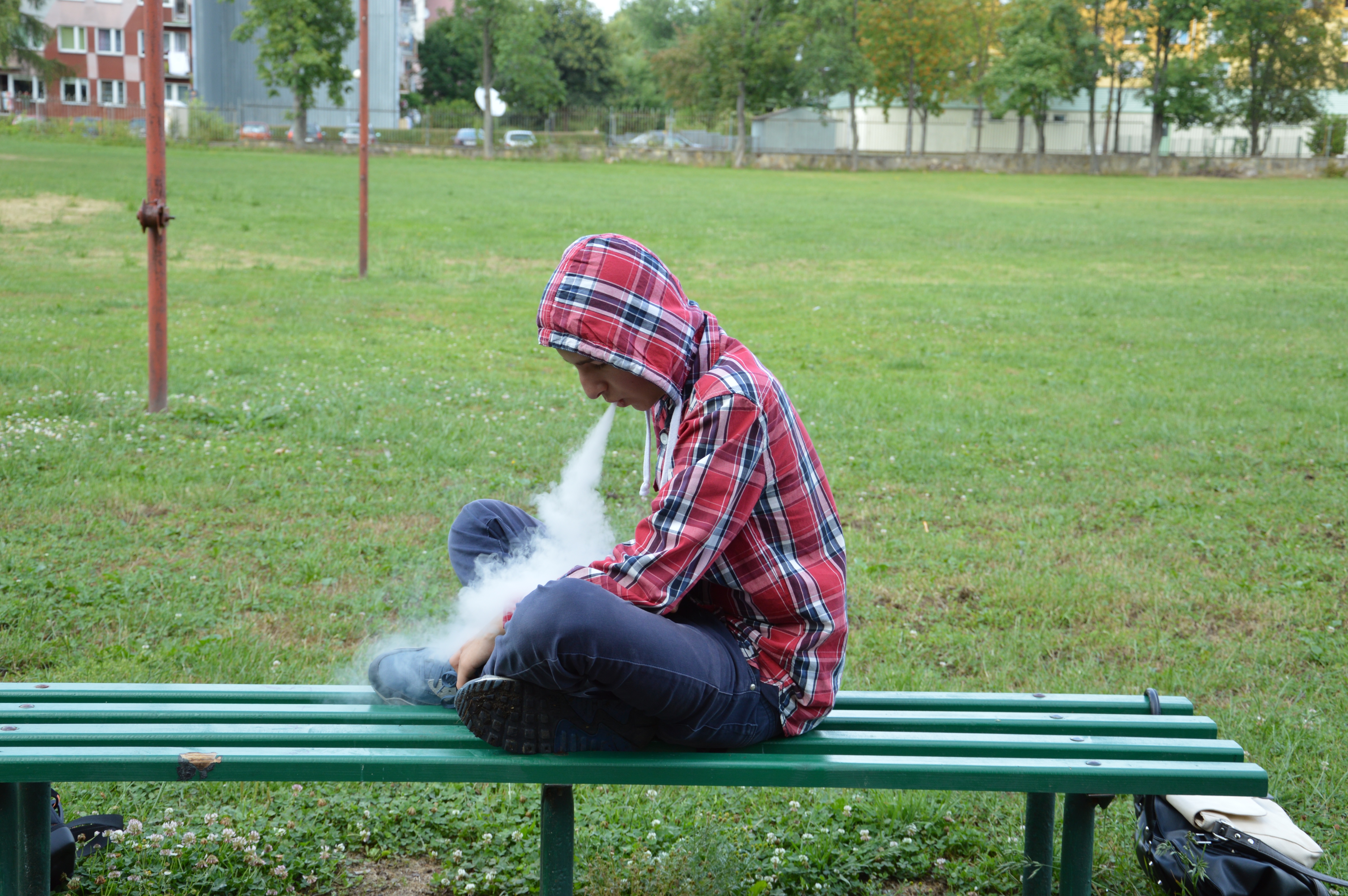 Man on bench blowing smoke : PxHere Public Domain